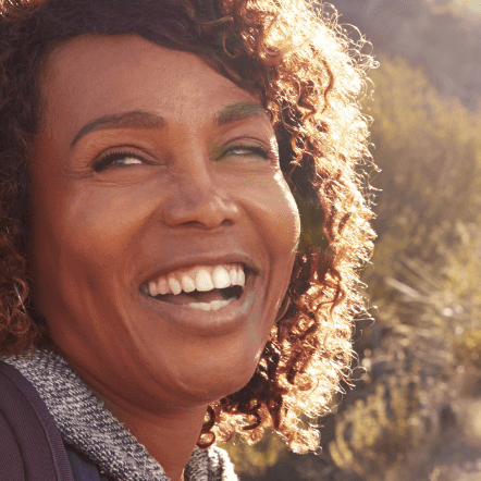 Woman hiking looks back with a smile