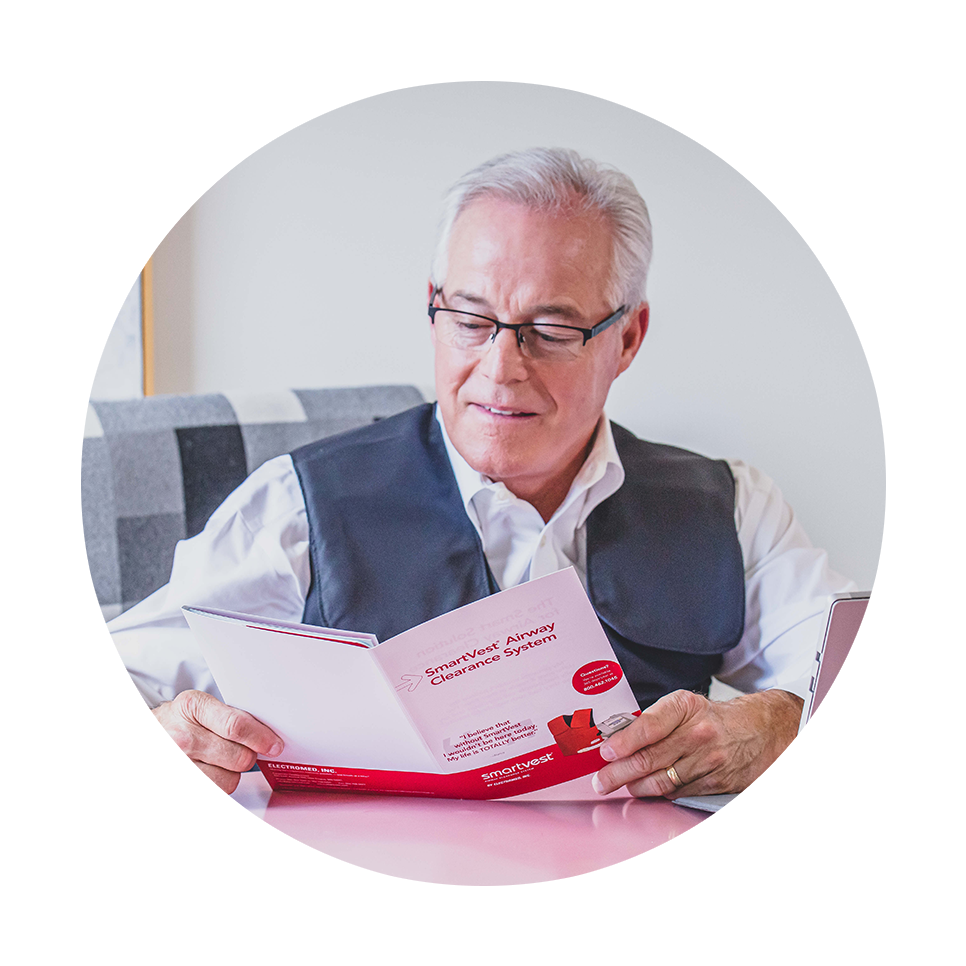 A man reads about SmartVest while wearing his HFCWO vest