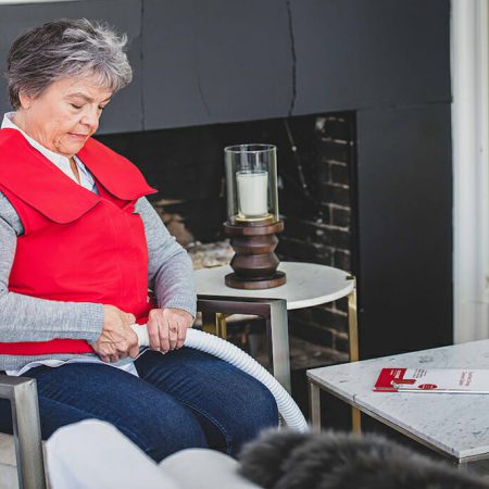 A woman connects her SmartVest generator to her vest