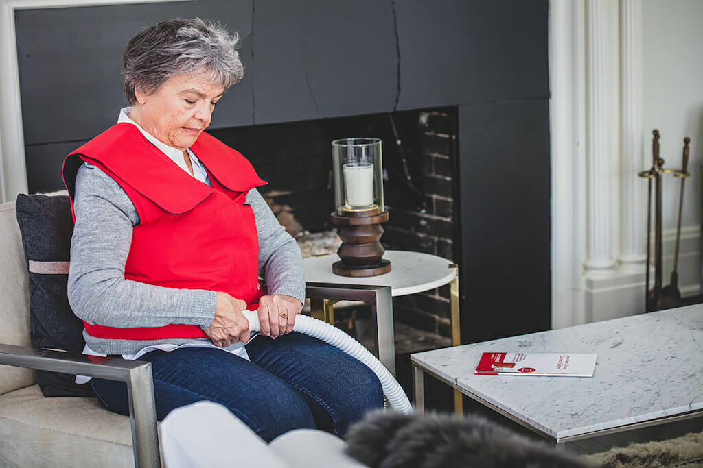 A woman connects her SmartVest generator to her vest