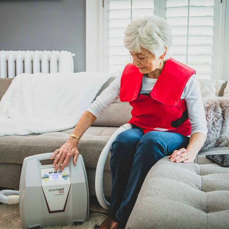 A woman adjusts the settings of her SmartVest generator
