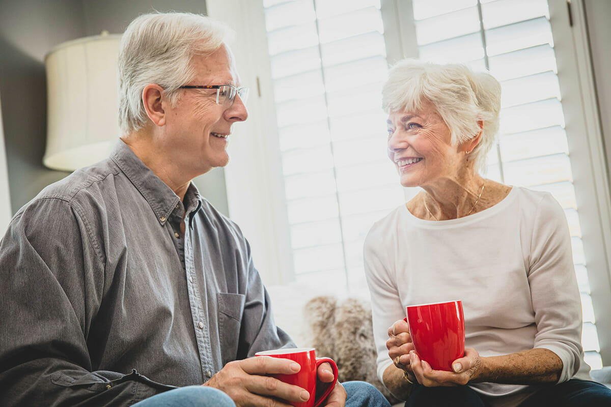 An older couple drinking coffee together