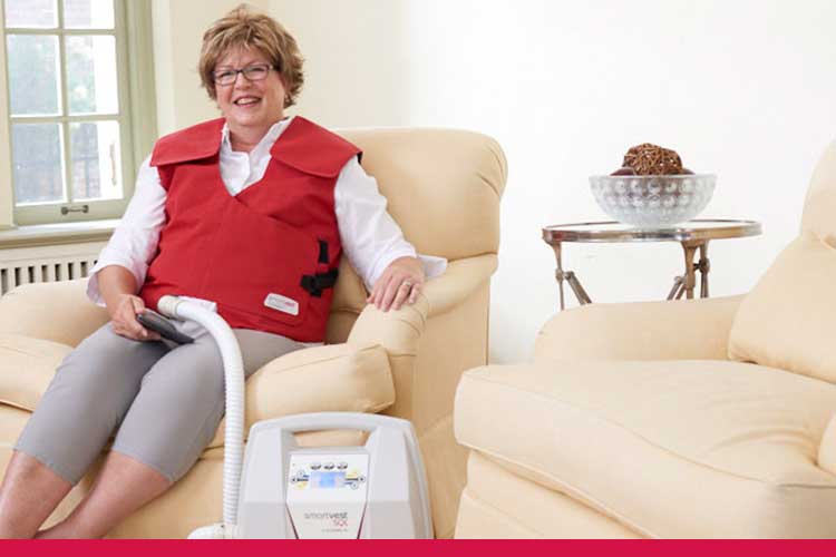 Woman using SmartVest Airway Clearance System