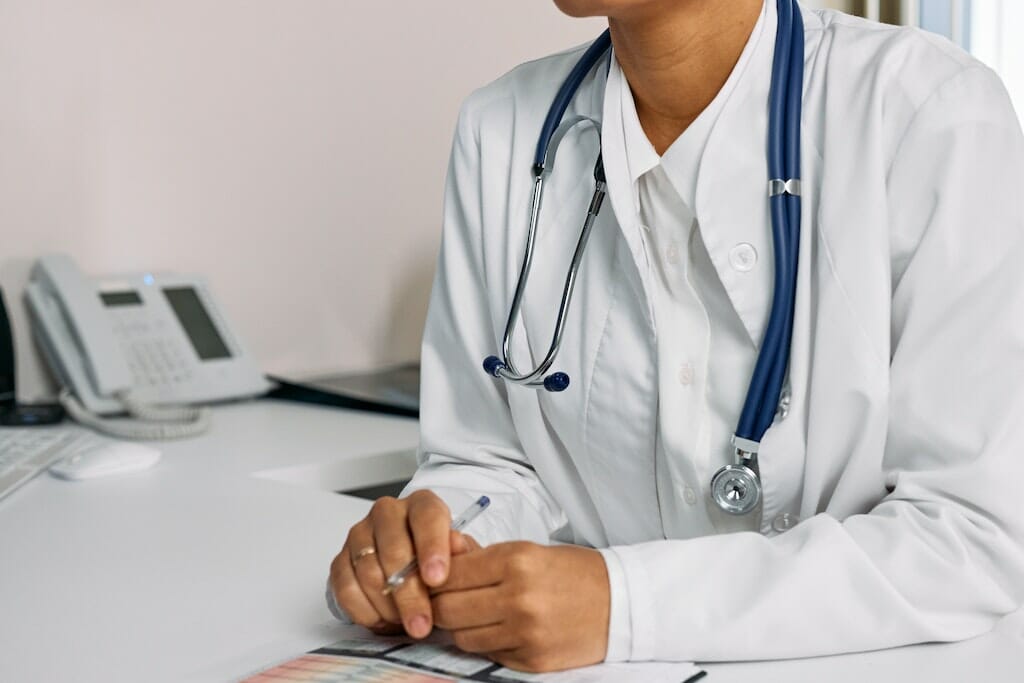 Close up of lung doctor talking over a bronchoscopy procedure with patient.