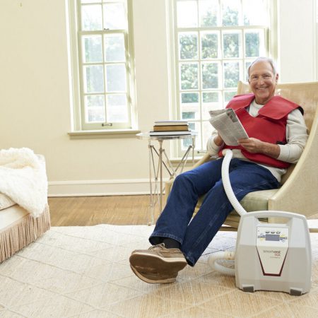 A man relaxes with a newspaper during his SmartVest therapy