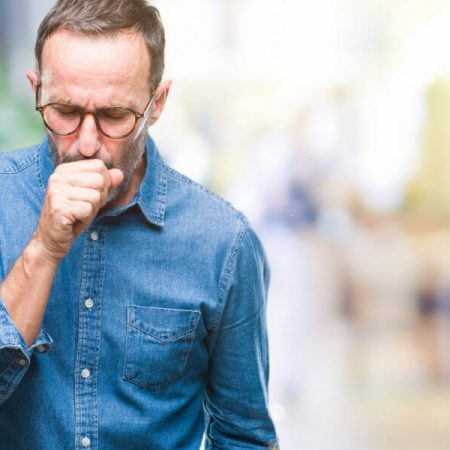 A man coughs into his hand