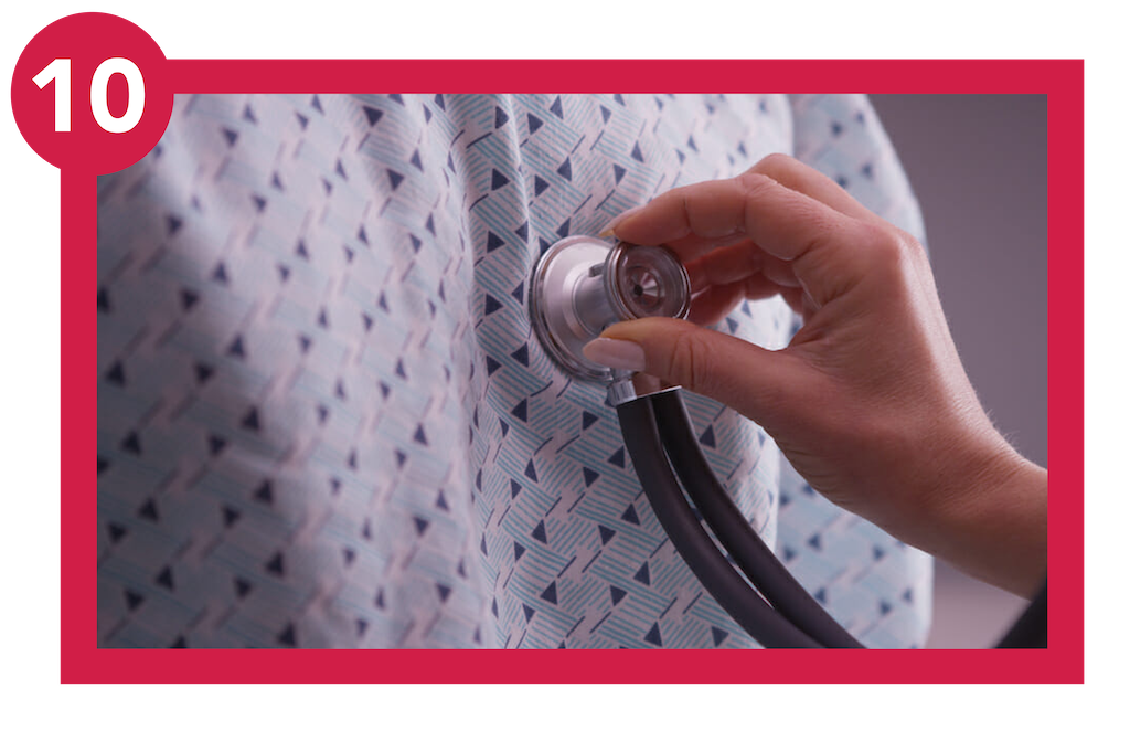 Clinician's hand using stethoscope to listen to patient's lungs.