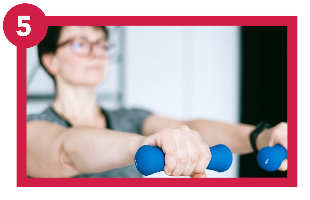 Woman living with respiratory condition holding hand weights in front of her chest.