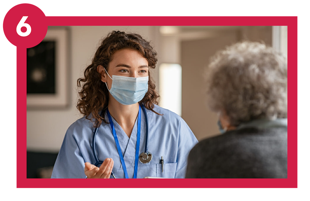 Clinician wearing mask while she talks to COPD patient in hospital..