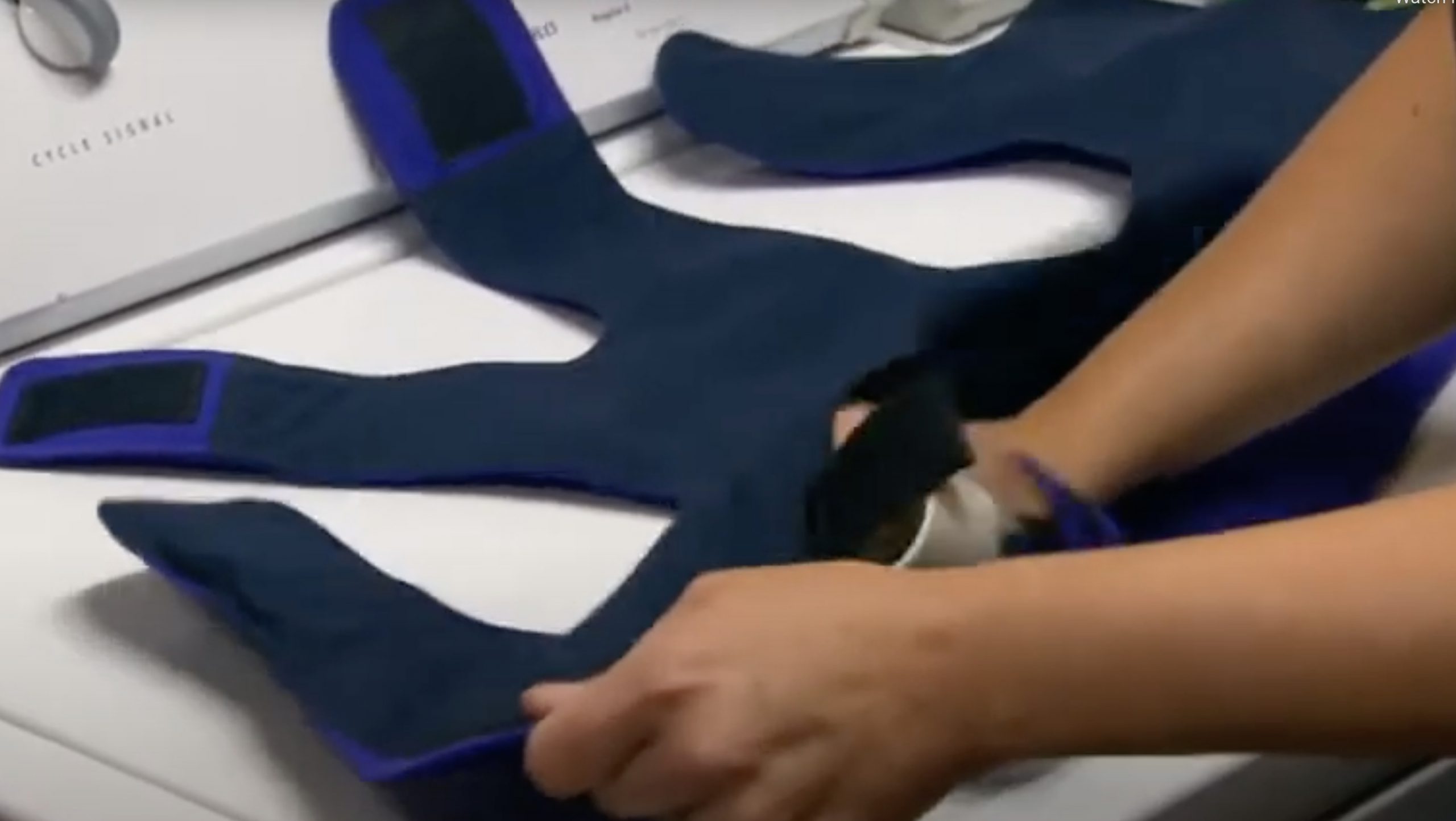 Woman opening up her SmartVest to remove the bladder.