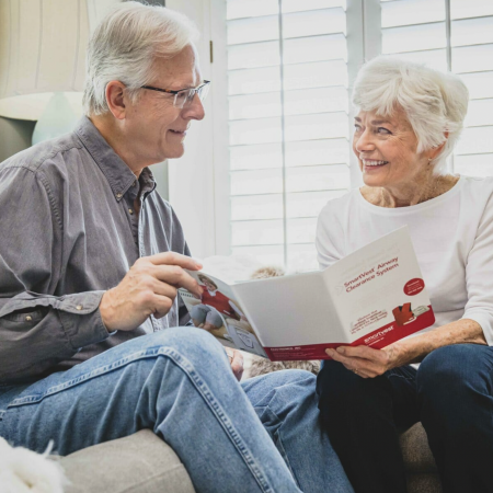 An older couple explores the SmartVest brochure together