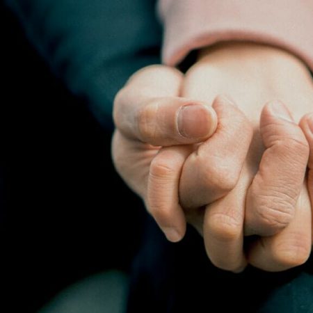 A couple holding eachothers hands