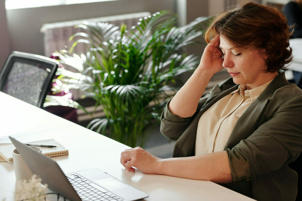 Woman with COPD holding her head