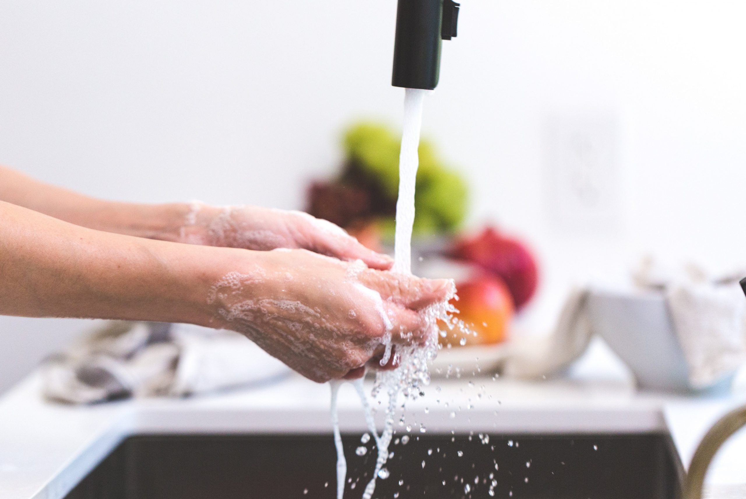 Woman washing hands under running water