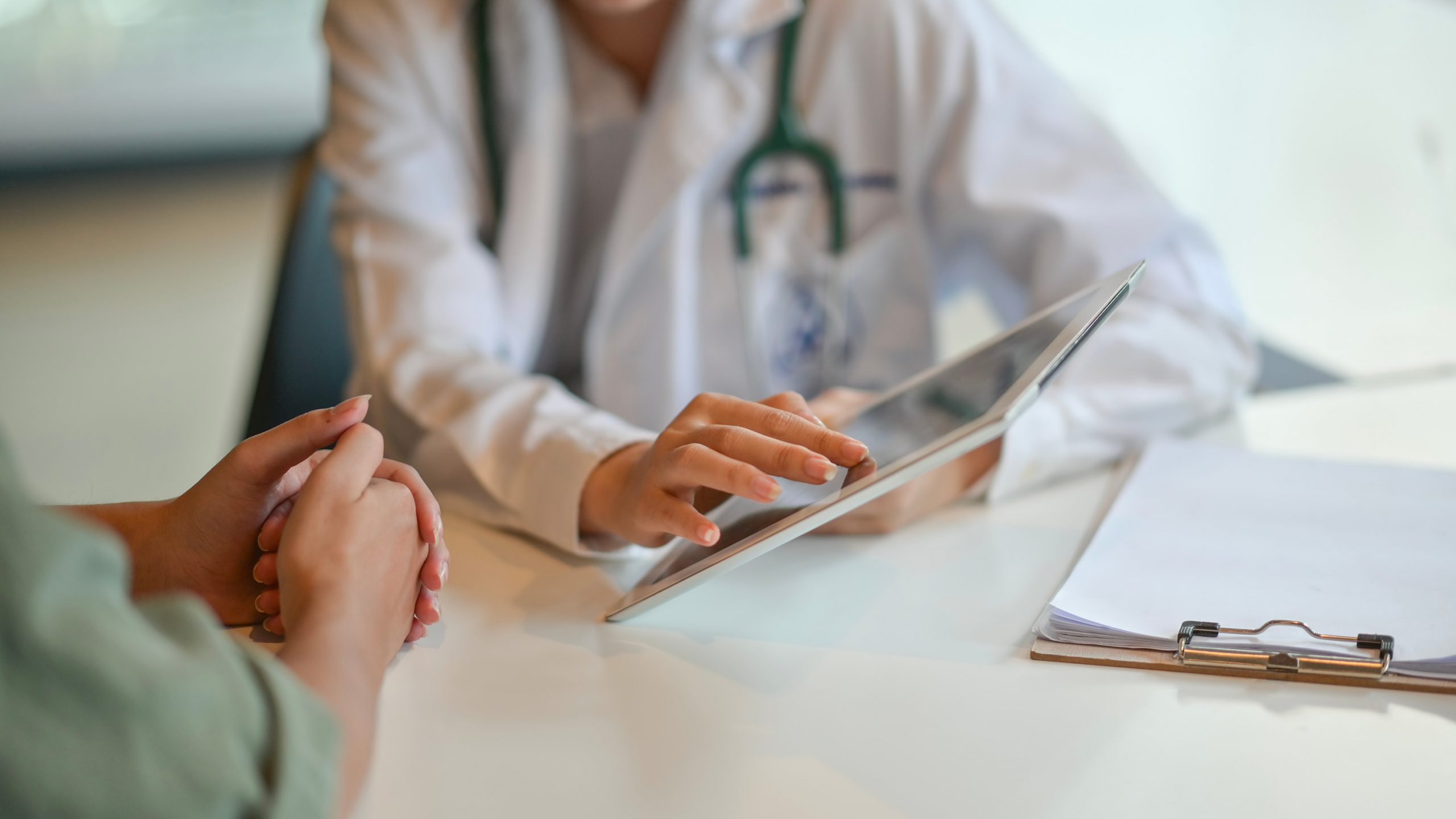 Clinicans holding iPad in front of patient discussing the benefits using SmartVest in a hospital setting