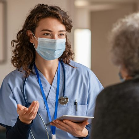 A doctor speaks with her client