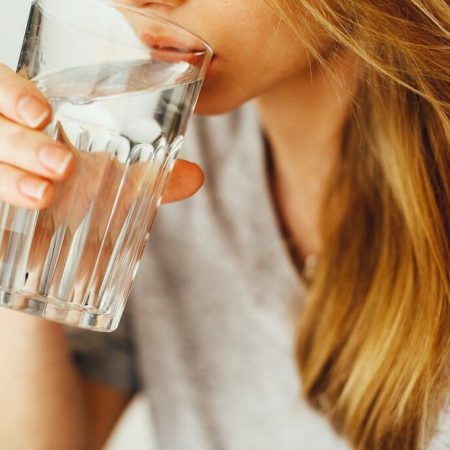 A woman drinking a glass of water