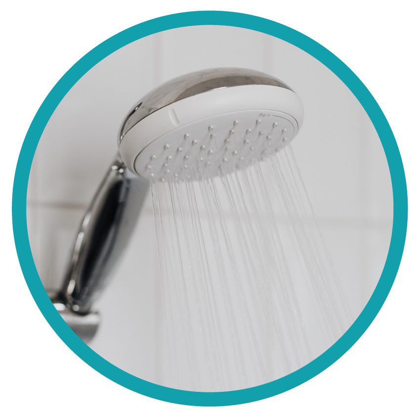Close up of shower head running water and creating steam.