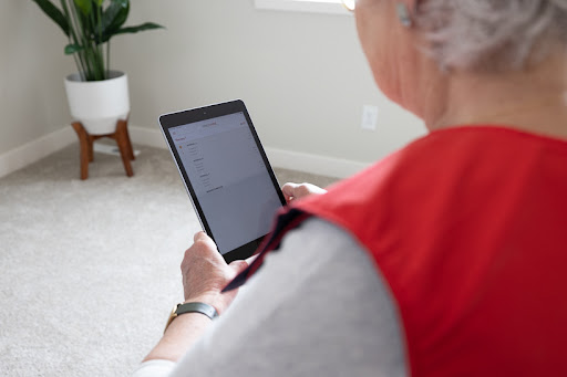 SmartVest patient using tablet while wearing vest.