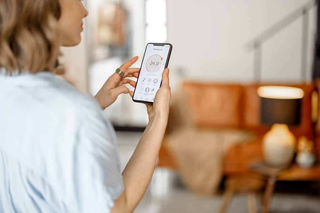 Middle-aged woman using the AQI app to check air quality in her area.