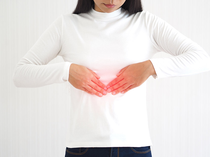 Woman holding diaphragm with red circle to indicate a diaphragm disorder.