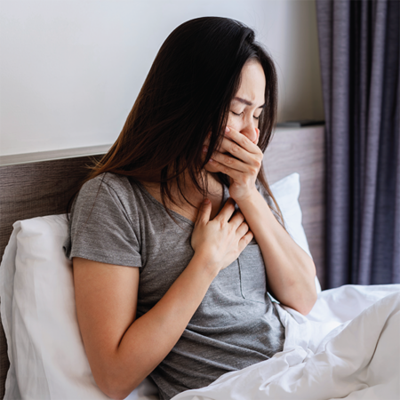 Woman with bronchiectasis experiencing morning cough.