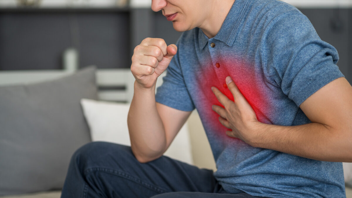 Man holding chest after experiencing a flare up.