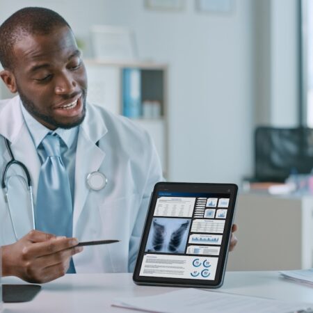 Doctor showing patient X-ray of lungs.