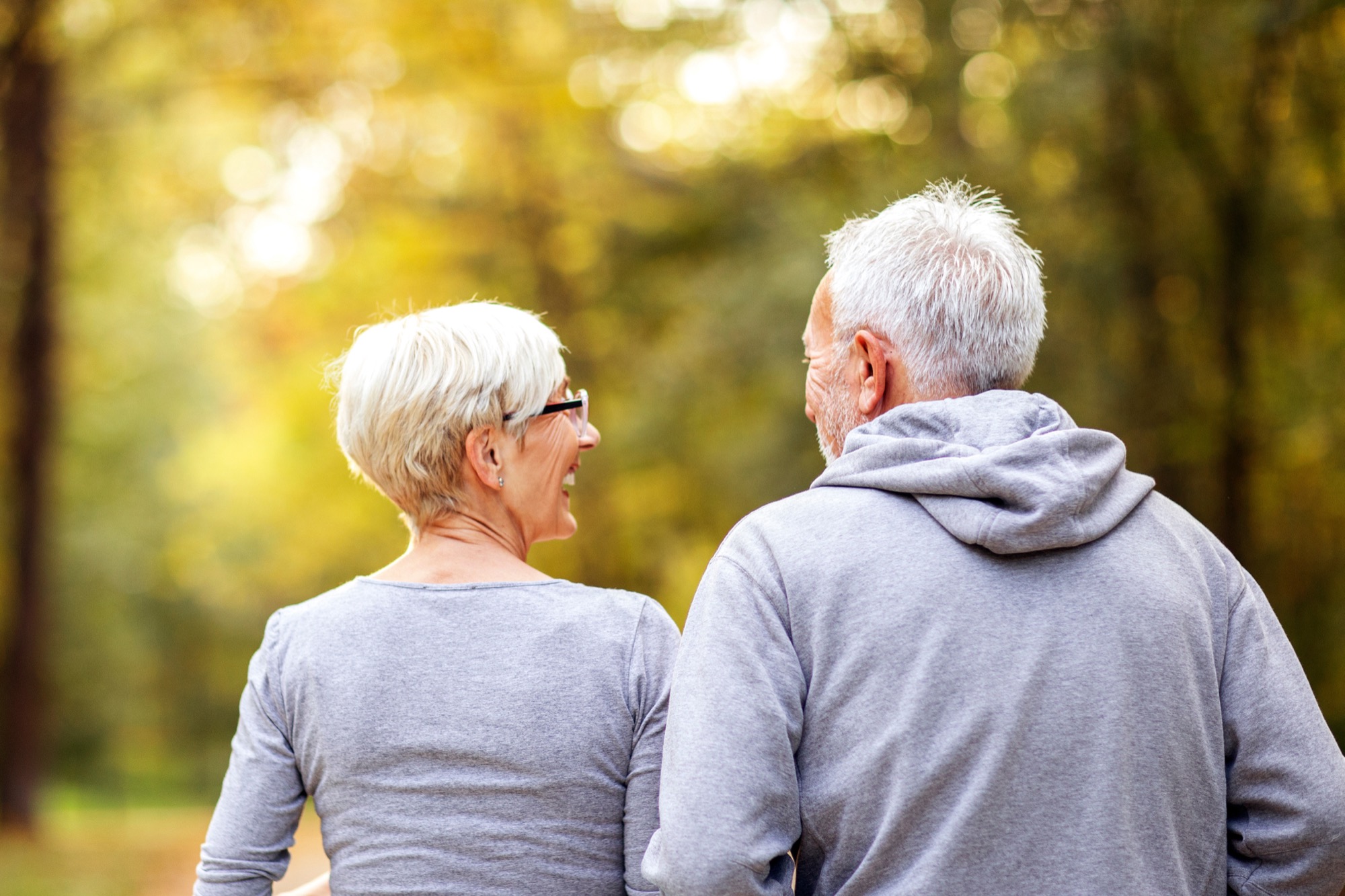 Mature couple man and woman jogging in the park