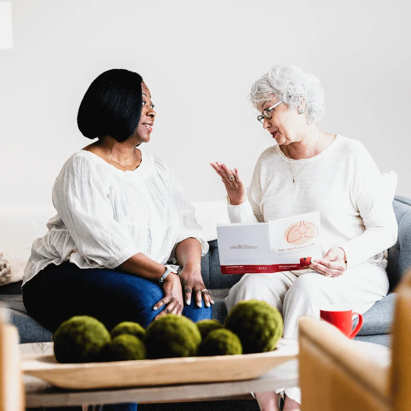 A patient discussing her impaired airway clearance with SmartVest uses her therapy while answering work emails.