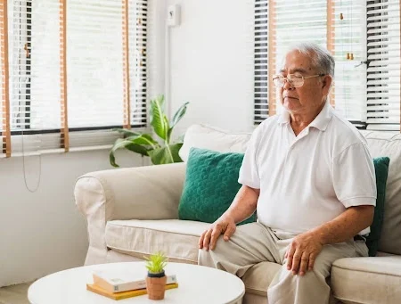 Man sitting on the couch breathing naturally.