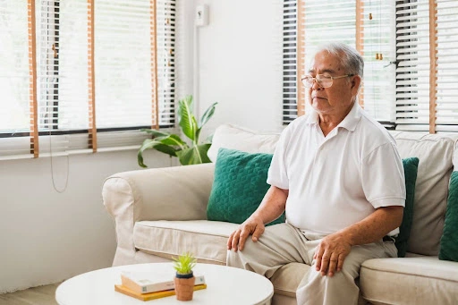 Man sitting on the couch breathing naturally.