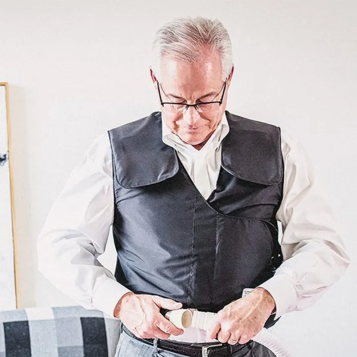 older man putting on a SmartVest to manage COPD