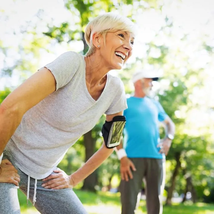 elderly outside in park stretching